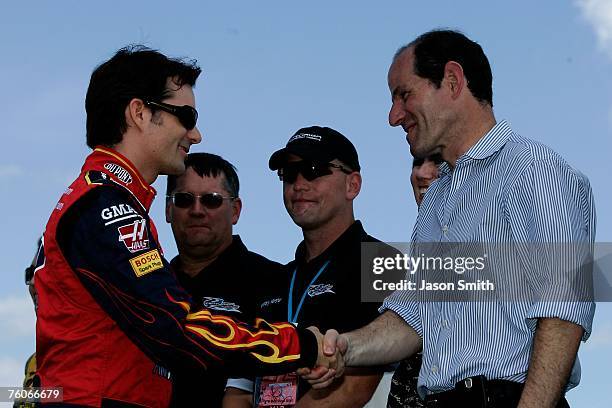 Jeff Gordon, driver of the DuPont Chevrolet, shakes hands with New York's governor, Eliot Spitzer during pre-race ceremonies prior to the NASCAR...