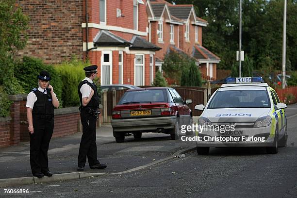 Police officers guard the scene in Station Road , where a 57 year old man was attacked by a gang of teenagers on friday and has died today on August...