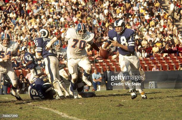 Los Angeles Rams quarterback Roman Gabriel rolls out to his left to avoid Denver Broncos defensive tackle Paul Smith in a 16-10 loss at the Los...