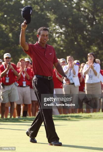 Tiger Woods walks to the award ceremony after his two-stroke victory at the 89th PGA Championship at the Southern Hills Country Club on August 12,...