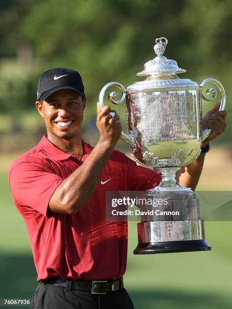 Tiger Woods celebrates with the Wanamaker Trophy after his two-stroke victory at the 89th PGA Championship at the Southern Hills Country Club on...