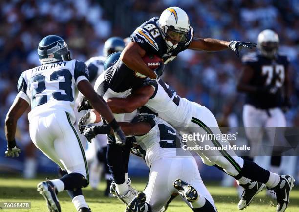Wide Receiver Vincent Jackson of the San Diego Chargers is tackled by the defense of Seattle Seahawks during their preseason NFL game on August 12,...