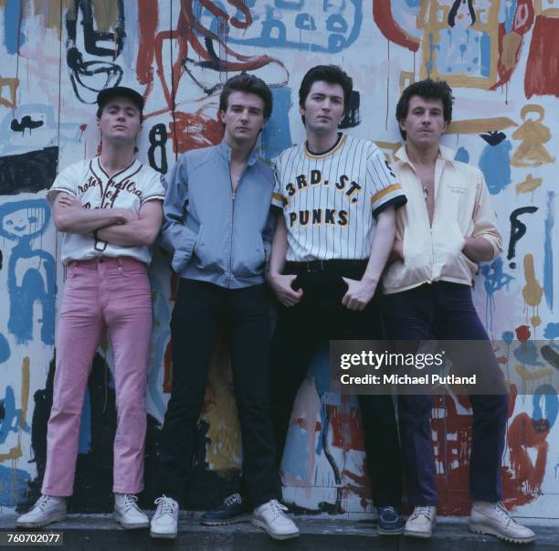 Scottish pop group Slik posed together wearing baseball tops, blouson jackets and Kickers boots in front of a painted backdrop in London, 20th May...