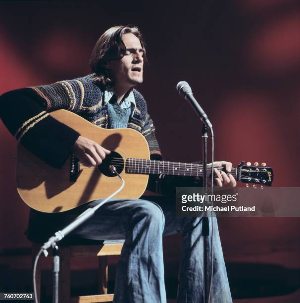 American singer-songwriter James Taylor performs with acoustic guitar on a BBC TV show in London, 20th October 1970.