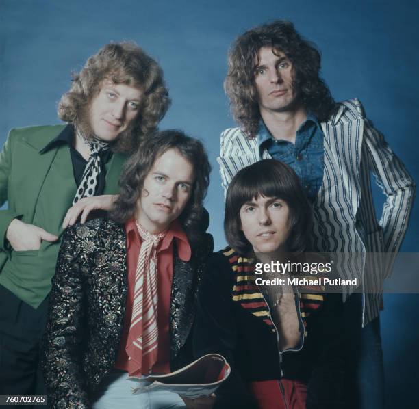 Studio portrait of English glam rock group Slade, posed in London circa 1974. The band are, from left: singer Noddy Holder, bassist Jim Lea,...