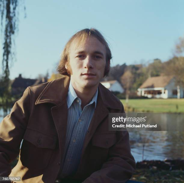 American singer, songwriter and guitarist Stephen Stills, of Crosby, Stills and Nash and formerly of Buffalo Springfield, posed beside a garden pond...