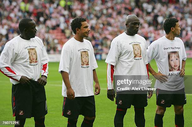 Dwight Yorke, Kieran Richardson, Nyron Nosworthy and Carlos Edwards of Sunderland line up wearing Madeleine McCann appeal shirts before the Barclays...