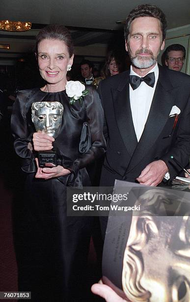 Audrey Hepburn and Robert Wolders during the BAFTA Awards on March 23, 1992 in London.