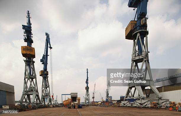 Cranes stand at the Blohm & Voss shipyard August 13, 2007 in Hamburg, Germany. Northern Germany, with its busy ports of Hamburg, Bremerhaven and...