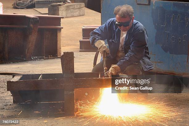 Welder welds a part of a ship at the Blohm & Voss shipyard August 13, 2007 in Hamburg, Germany. Northern Germany, with its busy ports of Hamburg,...