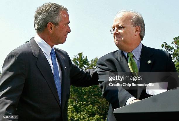 President George W. Bush looks at White House Deputy Chief of Staff Karl Rove after Rove announced that he will be resigning his post at the end of...
