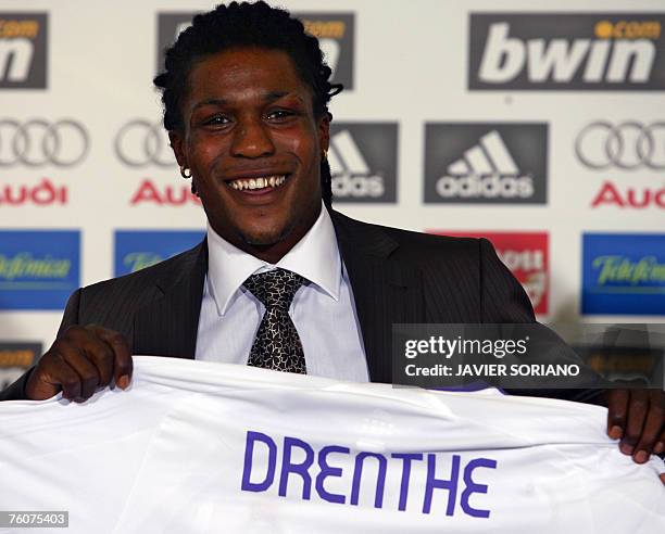 New Real Madrid football player, Dutch Royston Drenthe poses with his new t-shirt during his presentation at Santiago Bernabeu stadium in Madrid, 13...