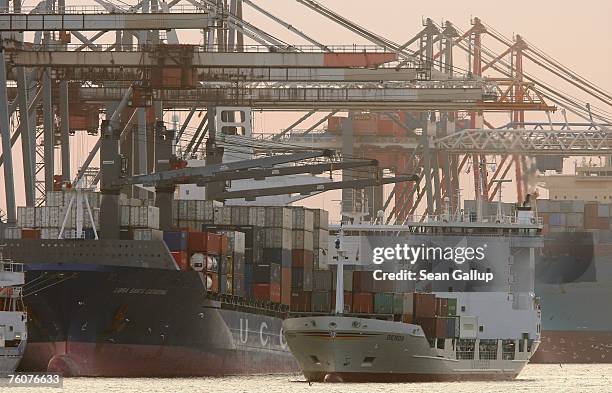 Container ship passes other container ships upon arriving at the main container port August 13, 2007 in Hamburg, Germany. Northern Germany, with its...