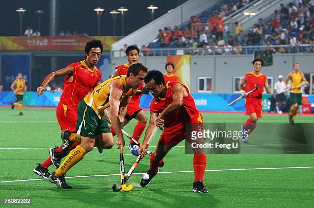 Liam Deyoung of Australia and Hu Huren of China compete for the ball during the Good Luck Beijing International Hockey Tournament match between...