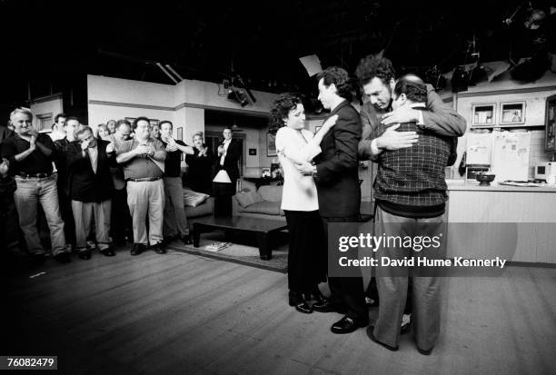 Julia Louis-Dreyfus, Jerry Seinfeld, Michael Richards and Jason Alexander embrace on the set of the show "Seinfeld" during the last days of shooting,...