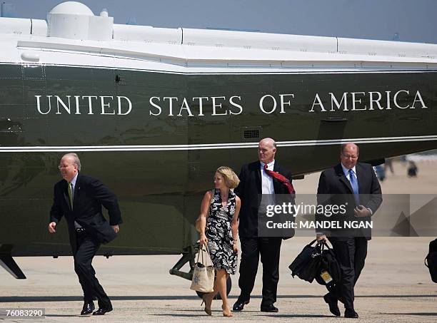 White House Deputy Chief of Staff Karl Rove runs towards US President George W. Bush beside Deputy Press Secretary Dana Perino and White House Deputy...