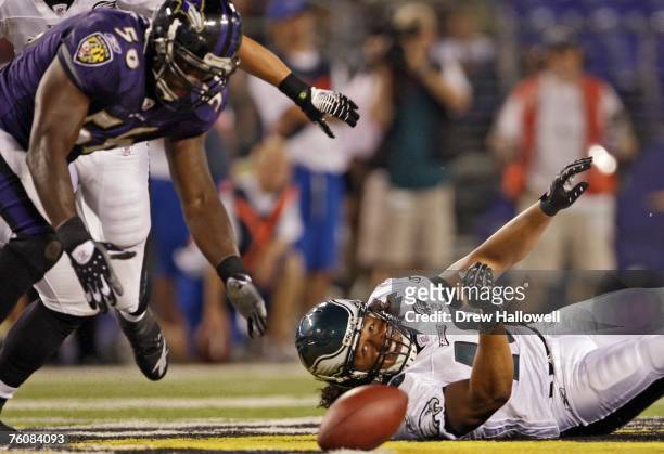 Running back Nate Ilaoa of the Philadelphia Eagles watches as linebacker Gary Stills of the Baltimore Ravens goes to scoop up a fumble in a...