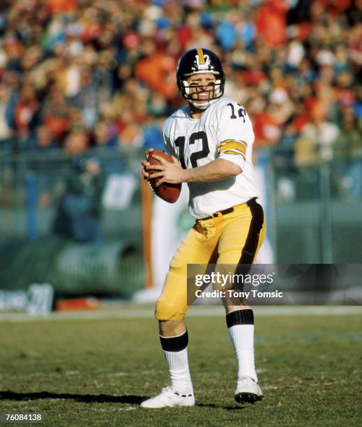 Quarterback Terry Bradshaw of the Pittsburgh Steelers looks to pass in a 34-21 loss to the Denver Broncos in the 1977 AFC Divisional Playoff Game on...