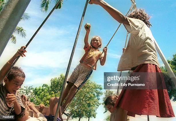 Children play April 16, 2002 on a beach in Dili, East Timor. United Nations-monitored vote counting in the presidential elections continued for a...