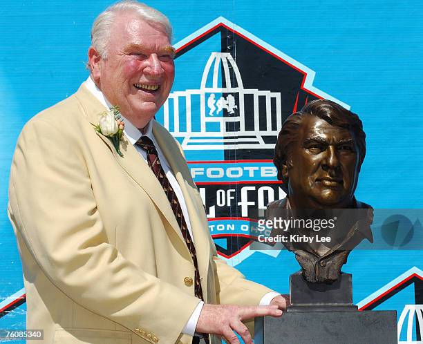 John Madden poses with bust at NFL Pro Football Hall of Fame Enshrinement at Fawcett Stadium in Canton, Ohio on Saturday, August 5, 2006.