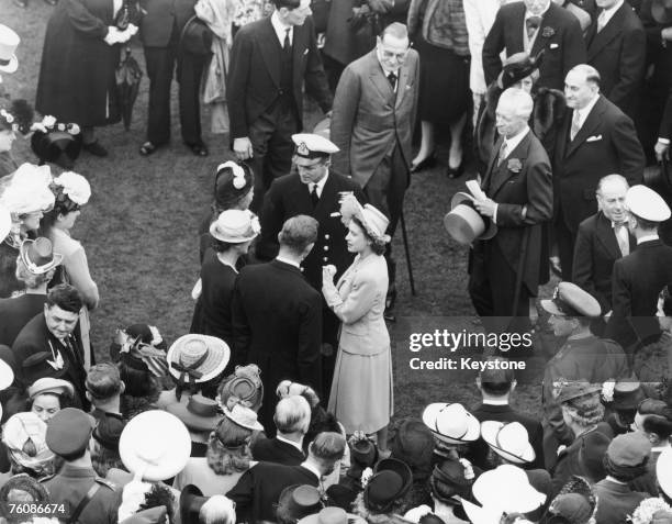 Princess Elizabeth and her fiance, Philip Mountbatten , at a Buckingham Palace garden party, 10th July 1947.