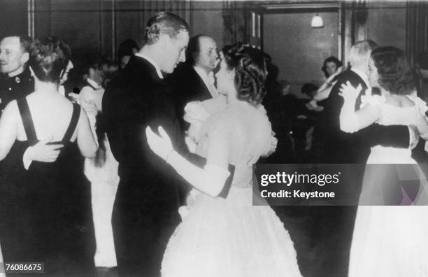 Princess Elizabeth dances with her fiance, Philip Mountbatten, in public for the first time at a ball at the Assembly Rooms, Edinburgh, 15th July...