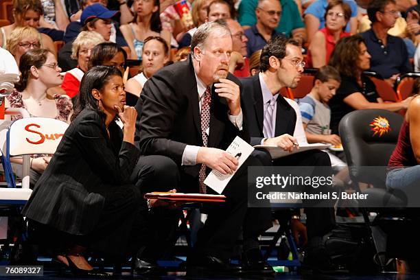 Assistant coaches Bernadette Mattox and Scott Hawk and trainer Jeremy Norman of the Connecticut Sun watch the game against the Houston Comets on July...