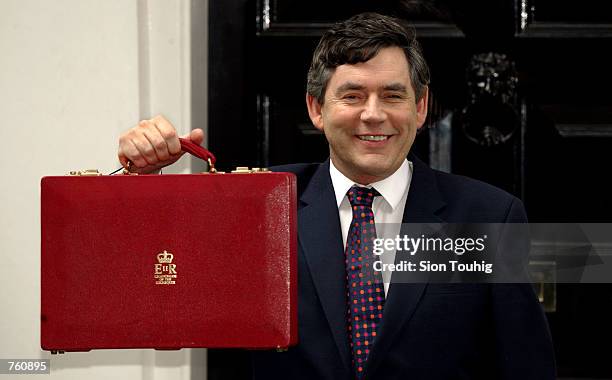 British Chancellor of the Exchequer Gordon Brown poses for photographers with his ministerial "red box" April 17, 2002 at his residence Number 11...