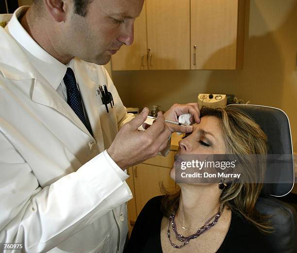 Dr. Louis P. Bucky, M.D., F.A.C.S., injects Botox into the face of Betsy Rubenstone from the Philadelphia area, April 18, 2002 at the Plastic &...