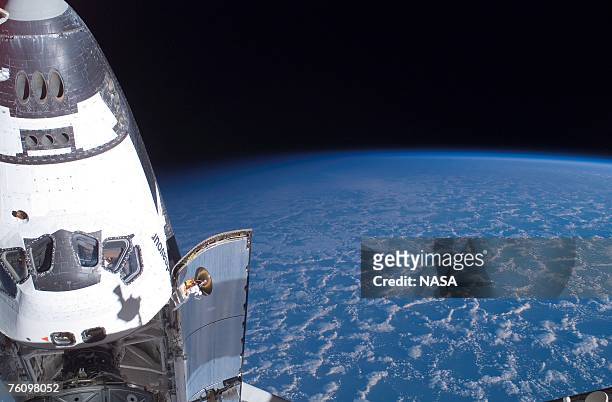In this handout photo provided by NASA, backdropped by the blackness of space and Earth's horizon, the Space Shuttle Endeavour, docked to the...