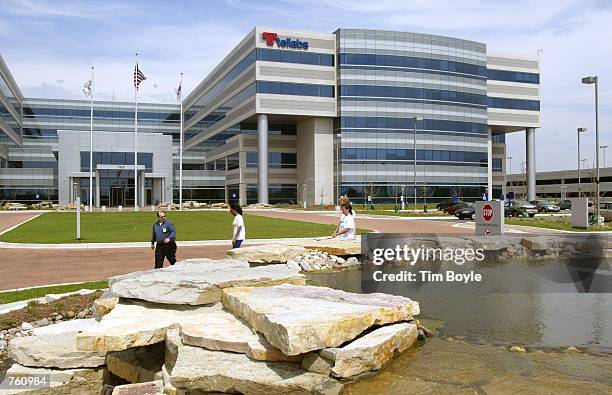 Tellabs Inc. Workers walk near a pond April 18, 2002 in Naperville, IL. The telecommunications equipment maker posted a 96 percent drop in...