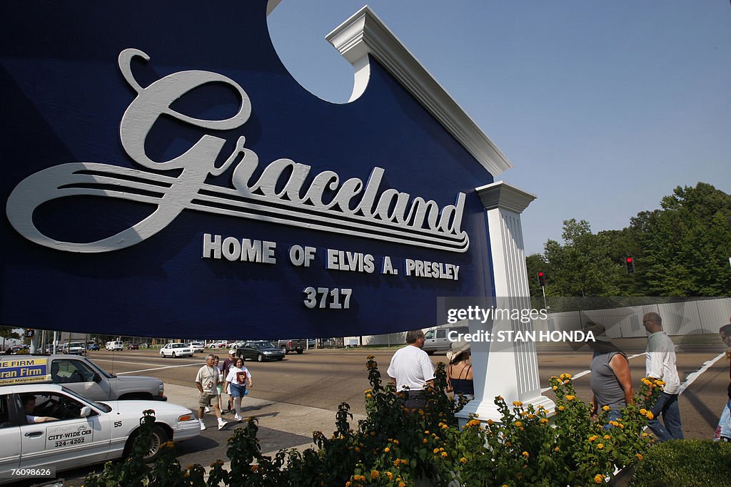 Fans walk by the entrance to Graceland,