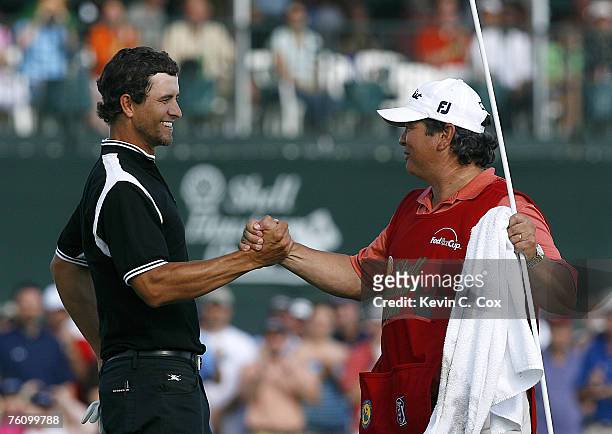 Adam Scott celebrates with his caddie Tony Navarro after winning the 2007 Shell Houston Open Sunday, April 1 on the Tournament Course at the Redstone...