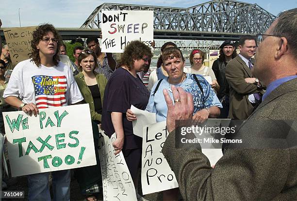 Homeless people and their advocates confront Mayor Butch Callery while protesting the removal of the homeless from their homes on the bank of the...