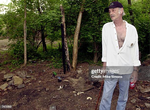 Homeless man Glenn West stands near the bank of the Ohio River where his home and belongings were taken away by officials April 19, 2002 in...