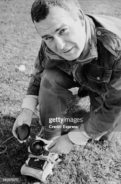 Express photographer Terry Fincher prepares to take a self portrait using a camera strapped to his foot, whilst parachuting from a hot air balloon,...