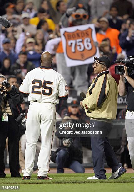 Barry Bonds of the San Francisco Giants celebratres with Willie Mays after hitting career home run against Mike Bacsik of the Washington Nationals on...