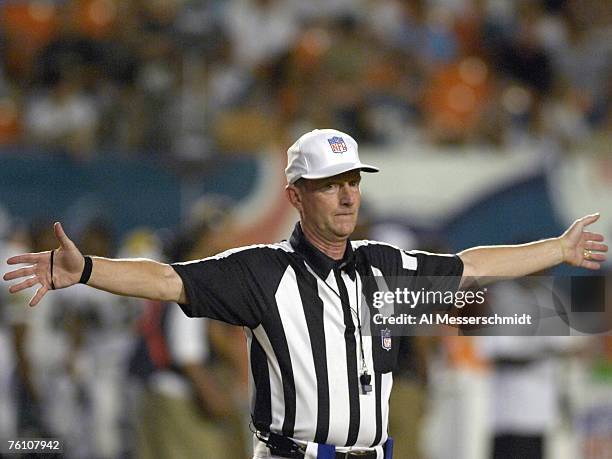 Referee Bill Carollo stops play as the Miami Dolphins host the Jacksonville Jaguars at Dolphin Stadium on August 11, 2007 in Miami, Florida.