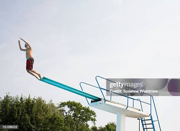 a boy on a diving-board. - diving board stock pictures, royalty-free photos & images