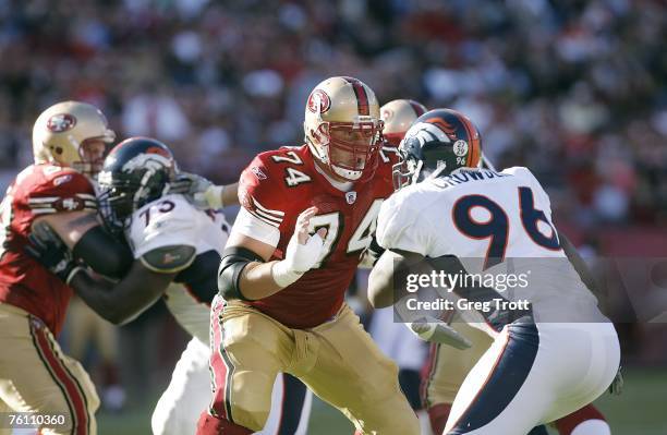 Offensive lineman Joe Staley of the San Francisco 49ers battles defensive lineman Tim Crowder of the Denver Broncos on August 13, 2007 at Monster...