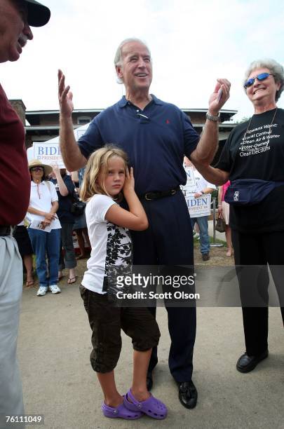 Democratic Presidential candidate, U.S. Sen. Joe Biden is hugged by his granddaughter Maisy Biden as he speaks to visitors at the Iowa State Fair...