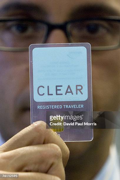 Rob Cimino, Senior Vice President of Clear, a new security program, holds up his fast pass card at the San Francisco International Airport on August...