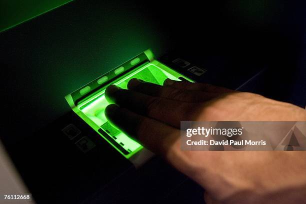 Sam Elgord has his finger prints scanned as he demonstrates Clear, a new security program, at the San Francisco International Airport on August 15,...