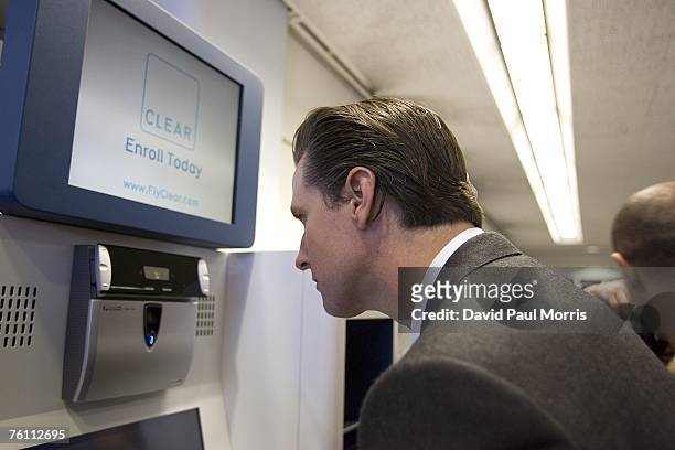 San Francisco Mayor Gavin Newsom has his irises scanned using Clear a new security program, at the San Francisco International Airport on August 15,...