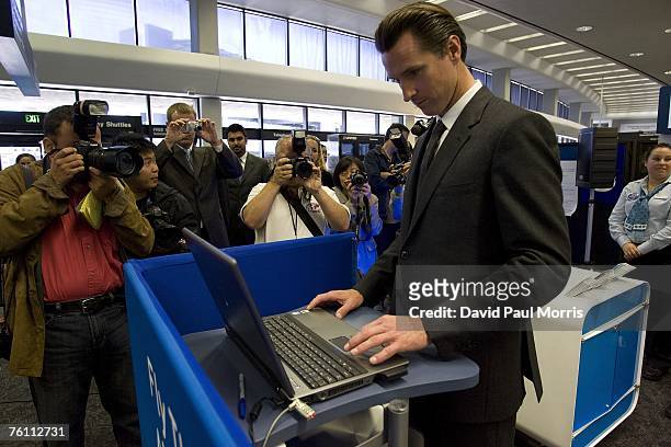 San Francisco Mayor Gavin Newsom signs up for Clear, a new security program, at the San Francisco International Airport on August 15, 2007 in San...