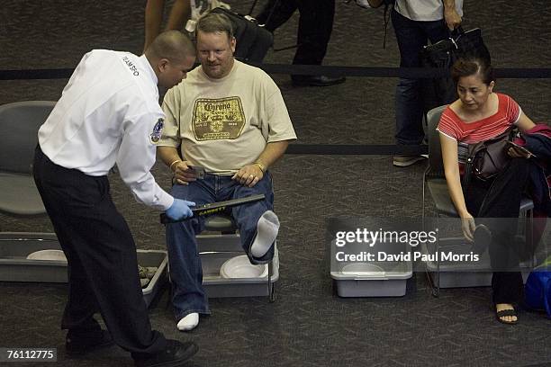 Man has his feet scanned using a traditional method the in security check point after a press conference announcing Clear, a new security program, at...