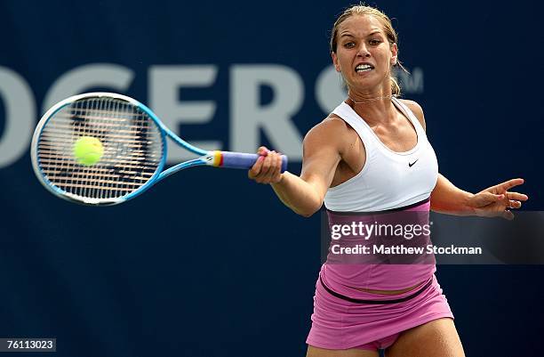 Domiinika Cibulkova of Slovakia returns a shot to Tatiana Golovin of France during the Rogers Cup August 15, 2007 at the Rexall Center in Toronto,...