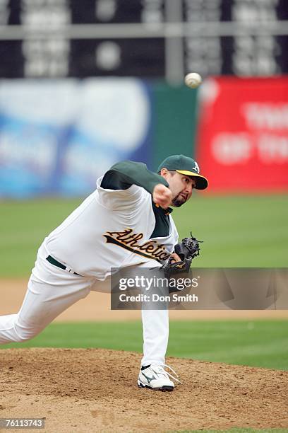 Andrew Brown of the Oakland Athletics pitches during the game against the Los Angeles Angels at the McAfee Coliseum in Oakland, California on August...