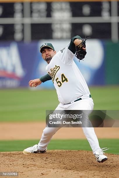 Andrew Brown of the Oakland Athletics pitches during the game against the Los Angeles Angels at the McAfee Coliseum in Oakland, California on August...