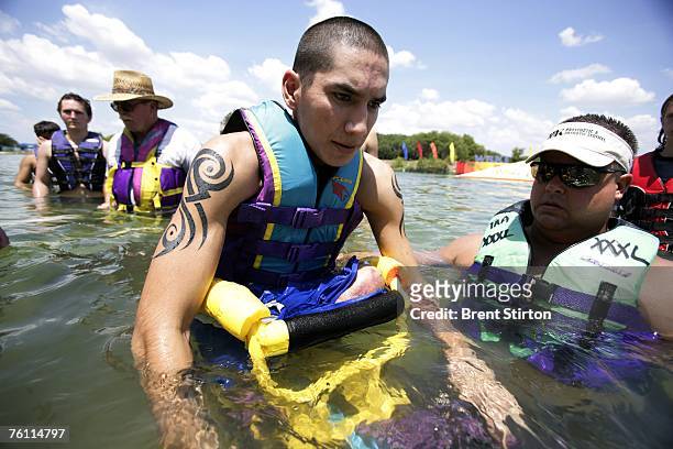 Josh Stein is pictured learning how to waterski using a specially adapted ski on August 23, 2006 in San Antonio, Texas. Stein is a double amputee...
